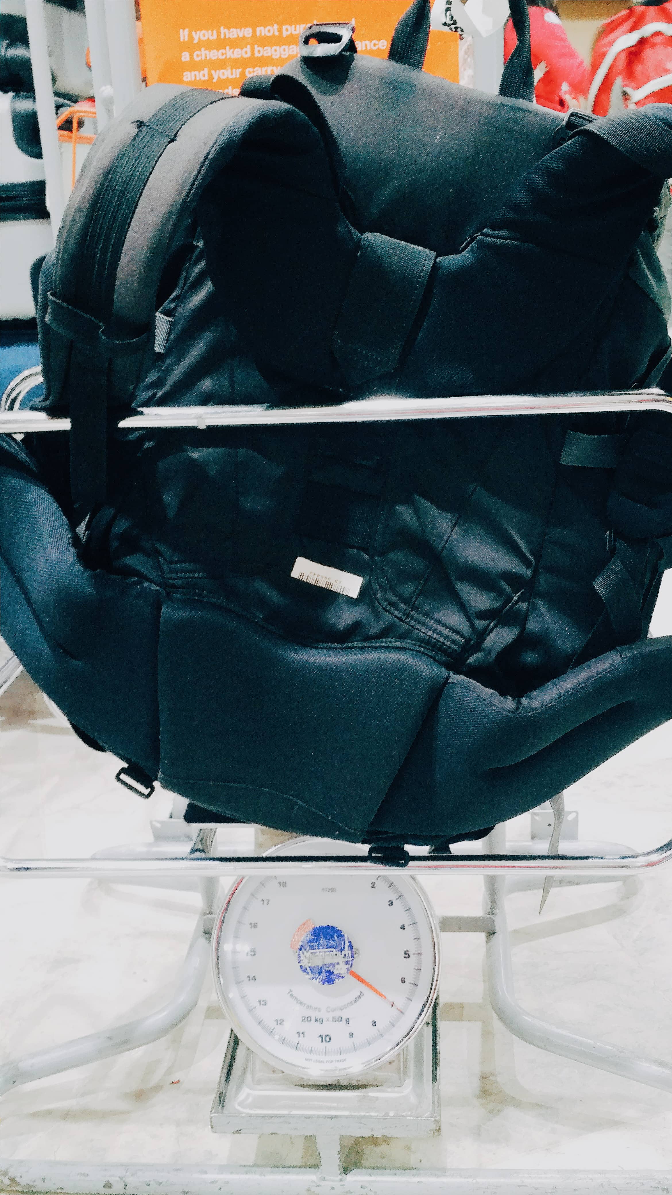 15 Common Travel Mistakes People Make Before Flying — And How to Avoid Every One 4 Tips To Avoid Paying For Hand Luggage, Weighing a traveling backpack in the airport.
