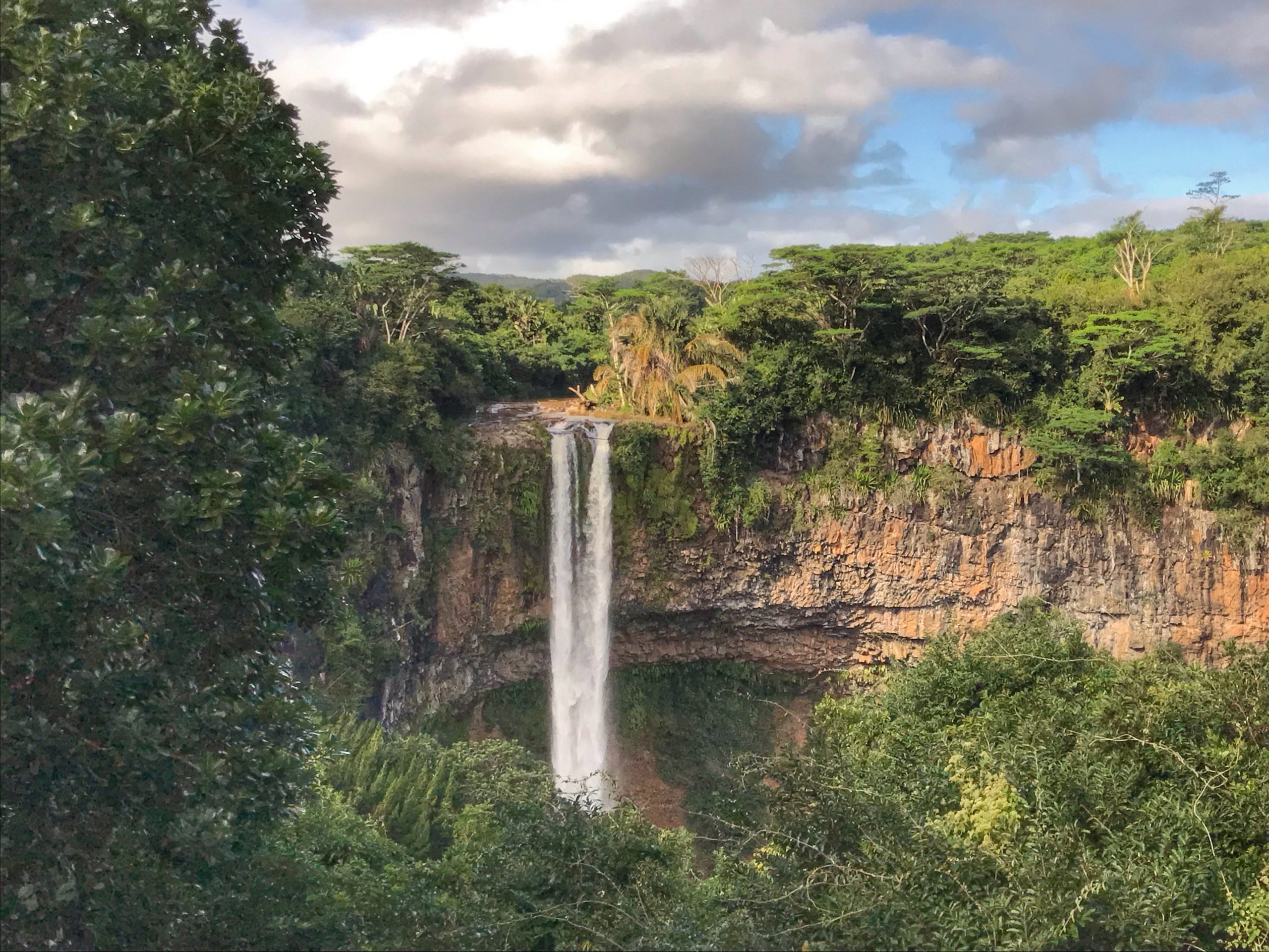 Americans Pay a Fortune to Move Abroad: These 12 Countries Will Pay You Instead 7 Waterfall in Mauritius scaled