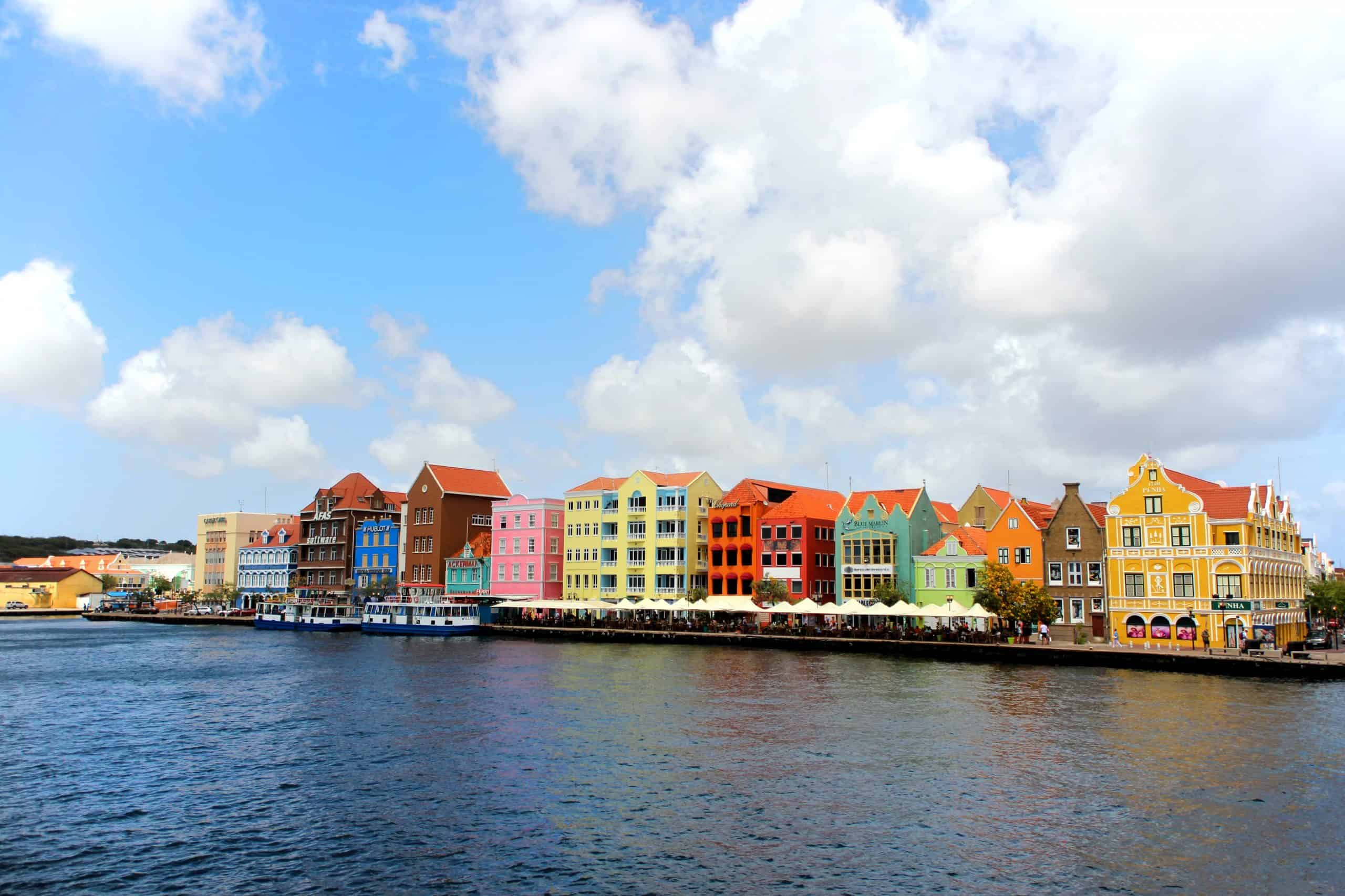 Comparison Aruba vs Curacao - Which is the Better Caribbean Trip? 30 Handelskade Waterfront of Willemstad as seen from the Queen Emma Bridge Curacao scaled